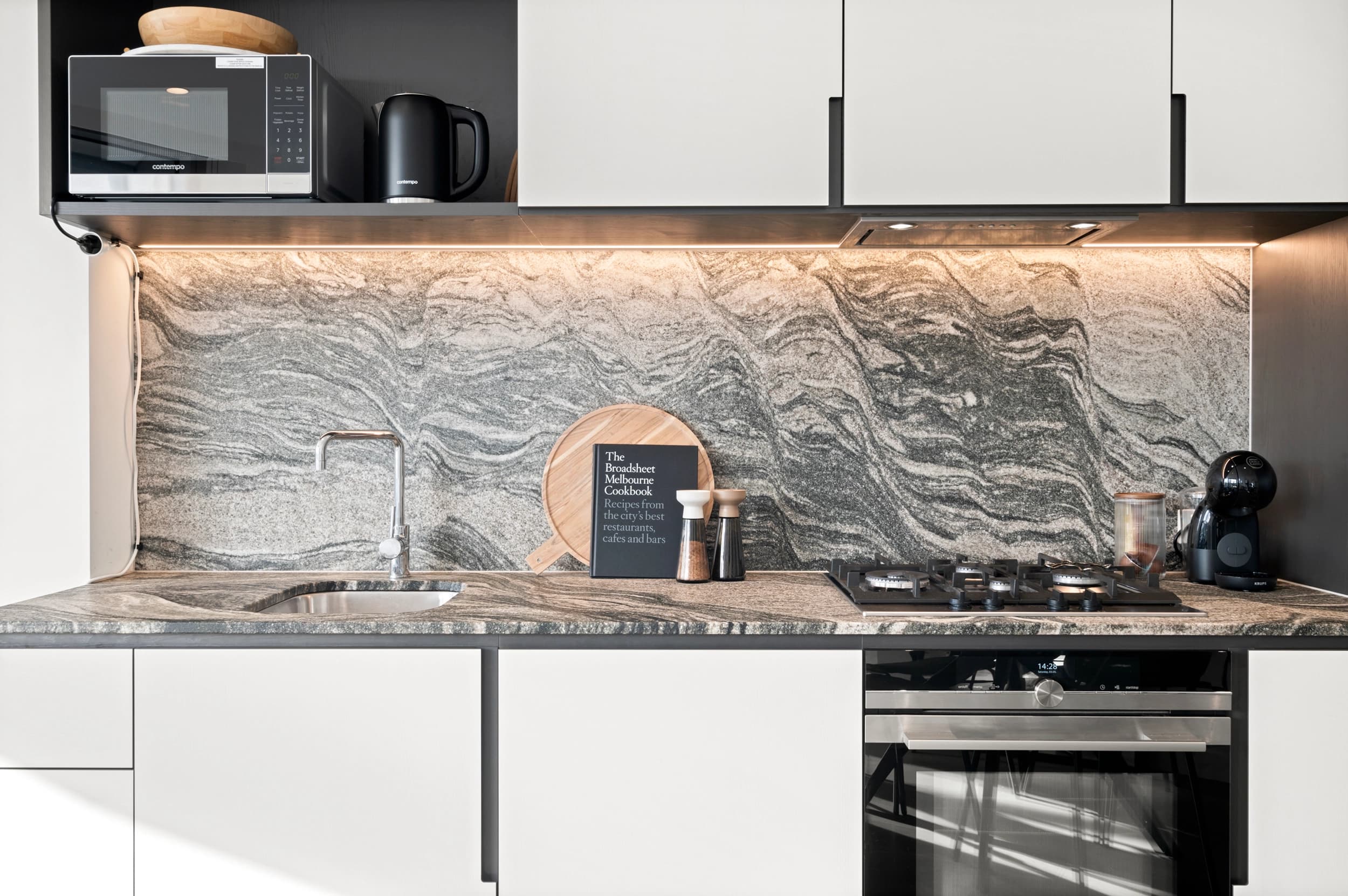 Modern home exterior at dusk with warm interior lighting